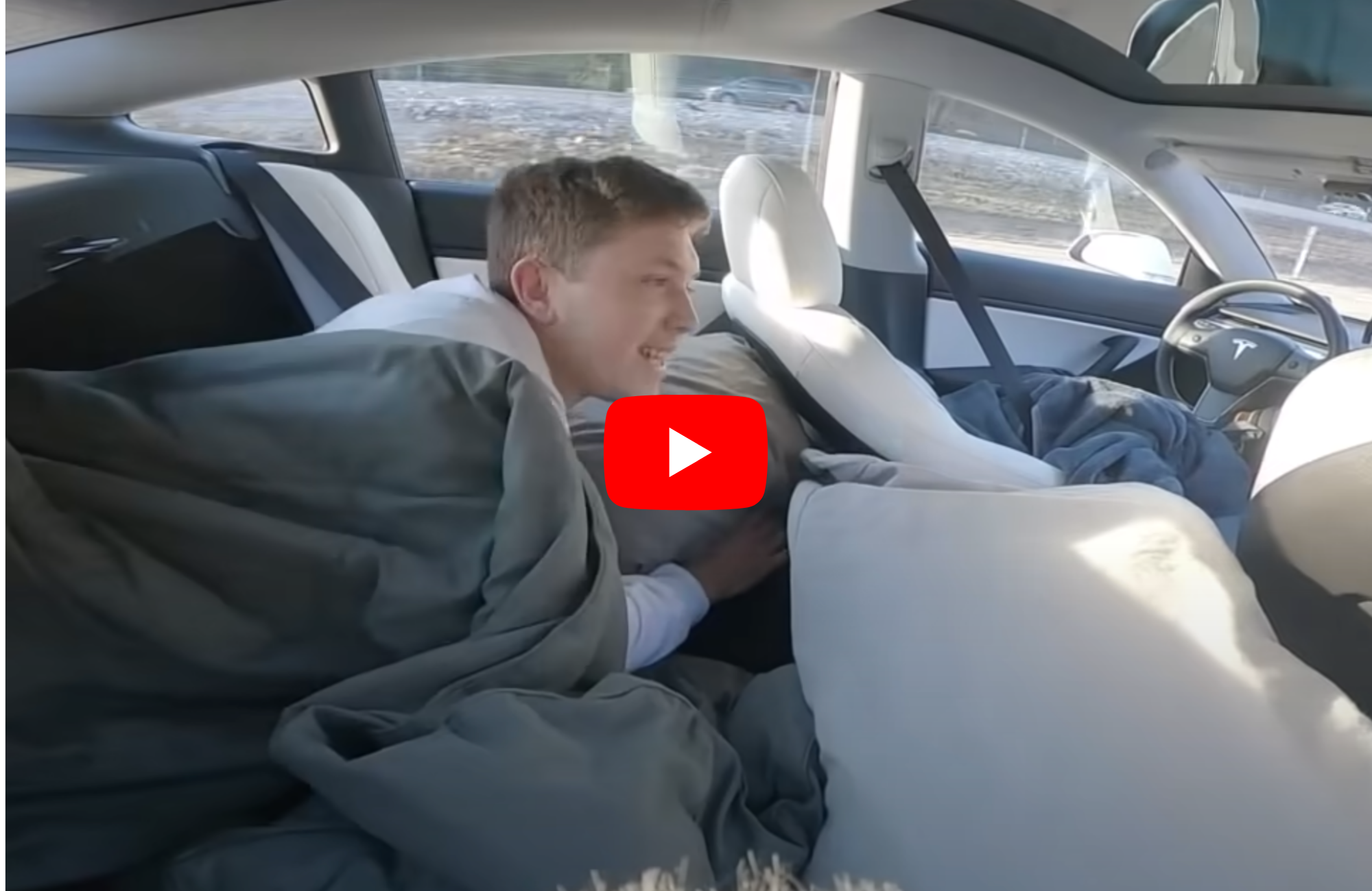 A driver sleeps in the back seat of a Tesla while its driving itself!
